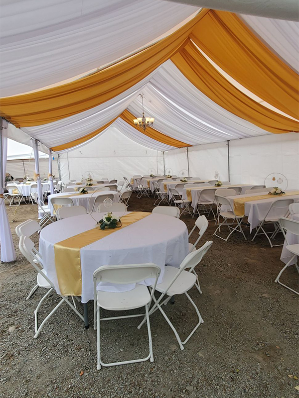 Elegantly decorated banquet table with chairs and tent